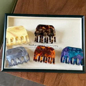 Detailed view of elegant Korean style acetate hair claws with marble textures for chic ponytails.