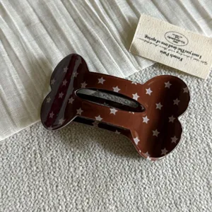 Molla per capelli a forma di osso marrone con stelle in dettaglio, accessorio