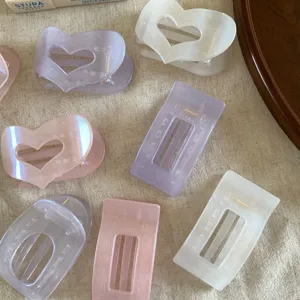 Pearl jelly hair claws with hollow heart and rectangle designs, elegant hair accessories.