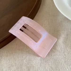 Pearlescent pink jelly hair claw clip, flat aesthetic design for comfortable daily hair styling.