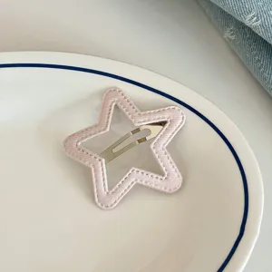 Pink star hair clip detail shot, sweet fabric styling and secure metal snap hair accessory.