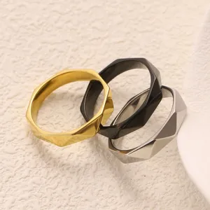 Detailed closeup of geometric faceted titanium steel rings in three classic colors.