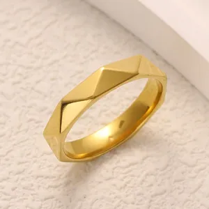 Detailed view of the geometric diamond lattice titanium steel ring, minimalist gold finish.