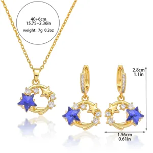 Gold-tone star jewelry set including necklace and matching earrings with blue crystal.