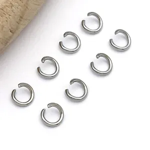 Detailed shot of silver tone open jump rings, perfect for DIY jewelry making and connecting.