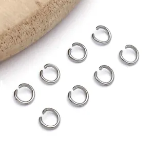 Close-up of stainless steel open jump rings for DIY jewelry making, silver tone findings.