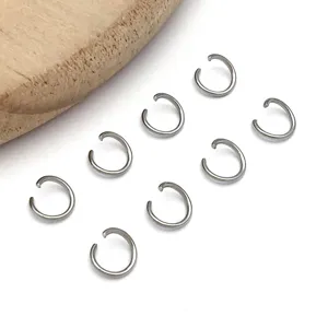 Close-up detail view of silver stainless steel open jump rings for DIY jewelry crafts.