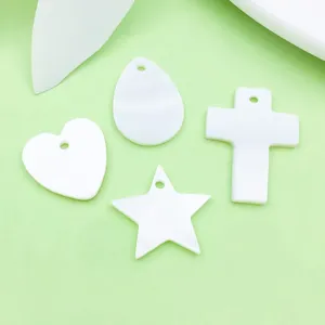 Nahaufnahme von weißen DIY Schmuckanhängern, verschiedene Formen wie Herz, Stern und Kreuz.
