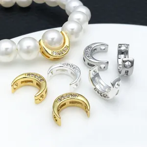 Detailed close-up of copper gold and silver plated moon zircon spacer beads for DIY jewelry making.