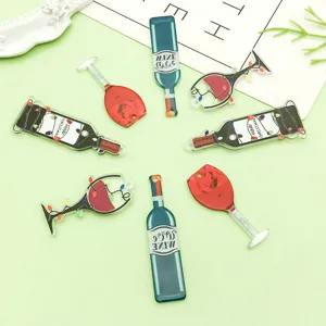 Detail shot of 8 mixed black and red acrylic wine bottle and goblet charms for DIY jewelry making.