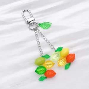 Gros plan détaillé de charms porte-clés en acrylique coloré avec chaînes en métal.