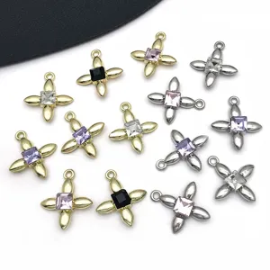 Close-up detail of KC gold and white K alloy square crystal clover pendants for DIY jewelry.