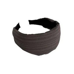 Dark fabric wide headband with parallel striped texture, minimalist hair hoop accessory.