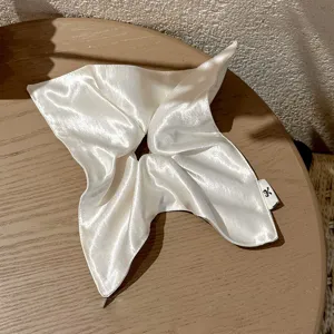 White satin hair scrunchie detail, elegant square scarf hair tie for stylish updos.