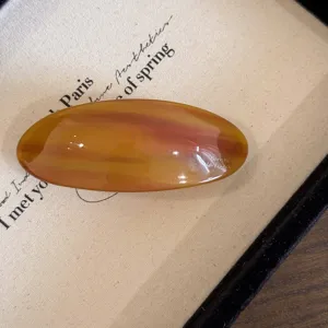 Detail acetaat haarspeld, elegante amberkleurige ovale barrette voor de dagelijkse haarstyling.