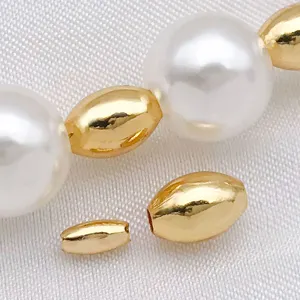 Close-up detail of glossy gold-plated small rice beads and pearls DIY jewelry accessory.