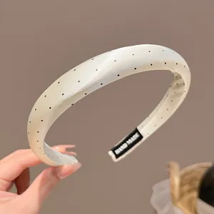 Chic polka dot satin headband detail, elegant cream white hair hoop with cute black dots.