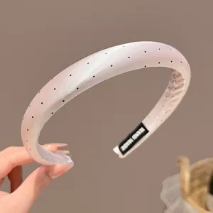 Close-up detail of Korean style polka dot satin thin headband hair accessory closeup