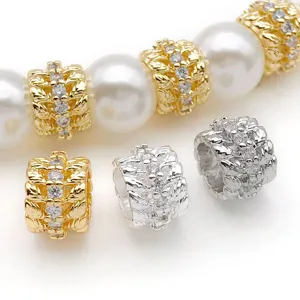 Detail view of gold and silver plated wheat leaf zircon spacer beads for DIY jewelry making.