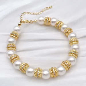 Gold-plated pearl bracelet detail featuring sparkling rhinestone spacer beads and adjustable chain.
