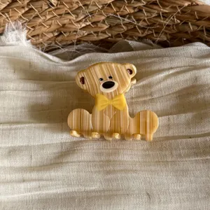 Close-up detail of the cute acetate bear hair claw clip with yellow bow, elegant and chic.