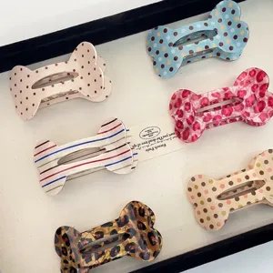 Cute bone shaped hair claw clips with colorful polka dots and leopard prints for women daily hairstyles.