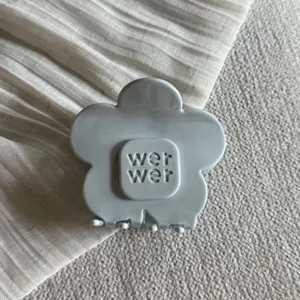 Gedetailleerd shot van een lichtblauwe bloem haarklem met leuk bloemdesign en sterke grip.