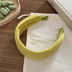 Serre-tête large en tricot jaune-vert clair, détail de tissu texturé pour un style quotidien.