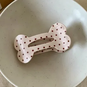 Cute polka dot bone hair claw clip detail shot, sweet aesthetic hair accessory for daily styling.