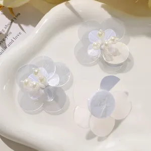 Detailed view of DIY double layer sequin flower patches with faux pearls for clothing.
