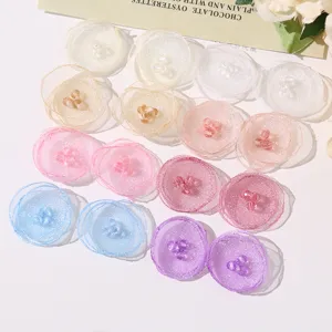 Detailed close-up view of colorful mesh fabric flower petals with crystal bead centers.
