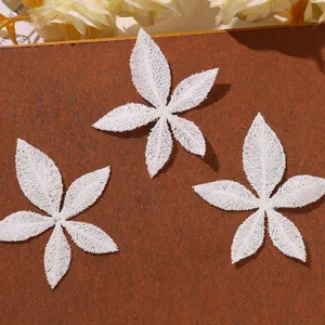 White lace embroidered flower patch detail, delicate five-petal floral DIY craft accessory.