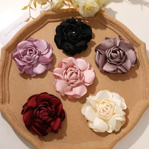 Detailansicht verschiedener Satin Kamelienblüten in bunten Farben für DIY Haaraccessoires.