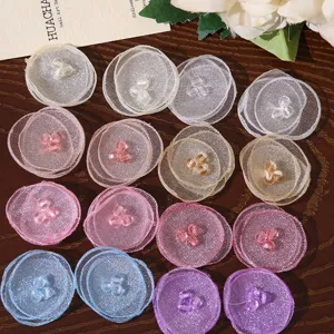 Close-up of colorful sheer mesh fabric flower petals with crystal bead centers, DIY craft supply.