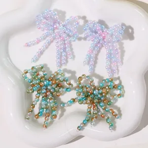 Detailed view of handmade beaded bow tassel patch for DIY crafts, shoes, and phone cases.