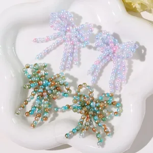 Detailed close-up view of handmade crystal beaded bow appliques showing intricate texture.