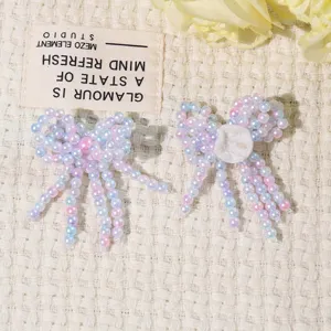 Detailed close-up shot of handmade beaded bow patch, sparkling crystal fringe, DIY acc.