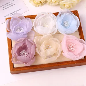 Detailed view of sweet mesh flower hair clips with pearl center in multiple colors.
