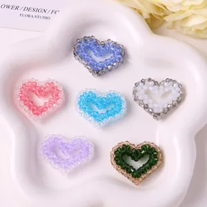 Colorful beaded heart DIY accessories detail shot, crystal craft charms for handmade jewelry.