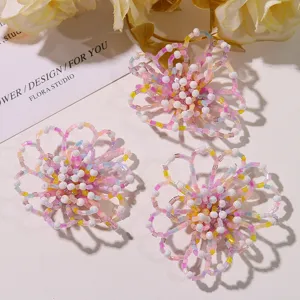 Handmade beaded hollow flower DIY accessory detail view, colorful crystal beads for craft.