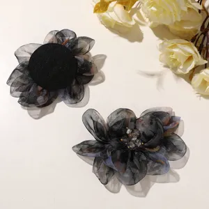 Detail shot of gradient black organza flower hair claw clip, featuring translucent petals and beads.
