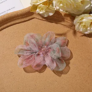 Exquisite detail shot of gradient organza peony flower hair claw clip with delicate bead stamens.