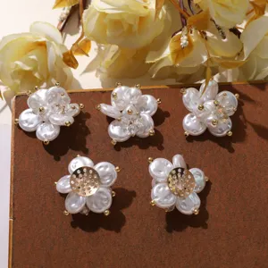 Detail shot of exquisite DIY pearl crystal beaded camellia flower accessories for shoes and jewelry.