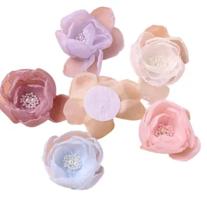 Sweet mesh flower hair accessories with pearl centers, multiple pastel colors displayed together.
