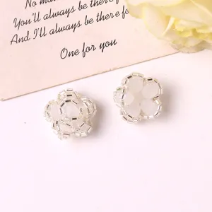 Close-up detail of handmade beaded flower jewelry accessories, crystal clear and white beads.