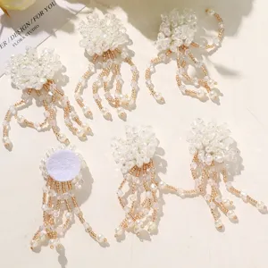 Close-up detail of handmade pearl and crystal beaded flower tassel DIY craft accessories.