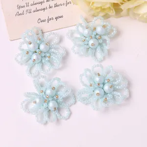 Detailed close-up of light blue beaded pearl hollow flower DIY accessories for crafts.