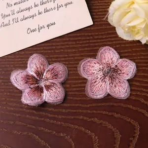 Close-up of pink embroidered five-petal flower patch, perfect for DIY craft accessories.