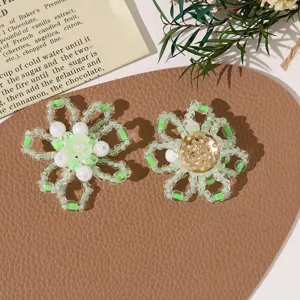 Detail view of handmade beaded flower DIY accessories, featuring fresh green and white glass beads.