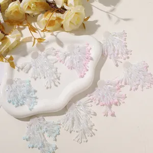 Close up of handmade beaded tassel flower accessories, showing delicate white and pink bead details.